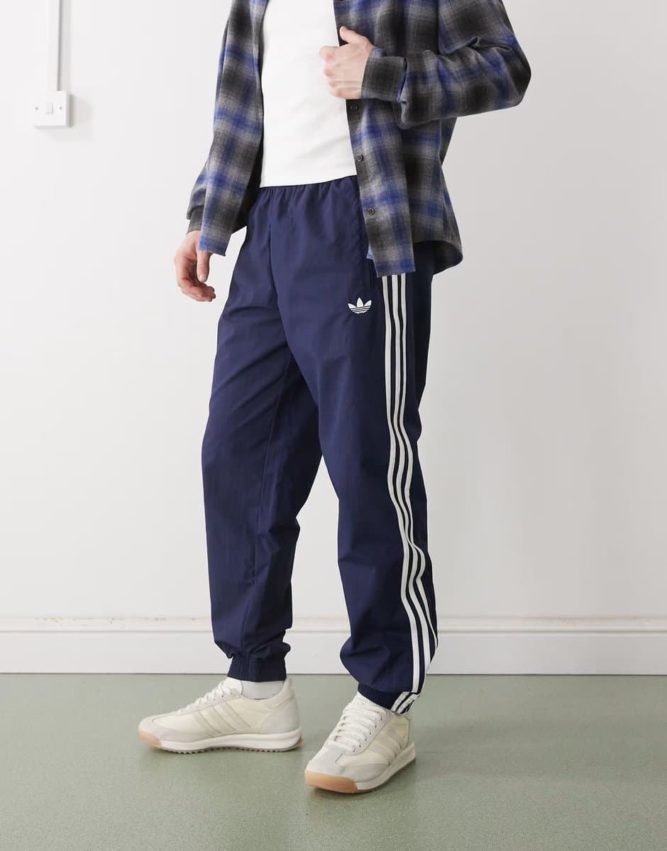 ASOS adidas Originals Firebird woven track pants in night indigo