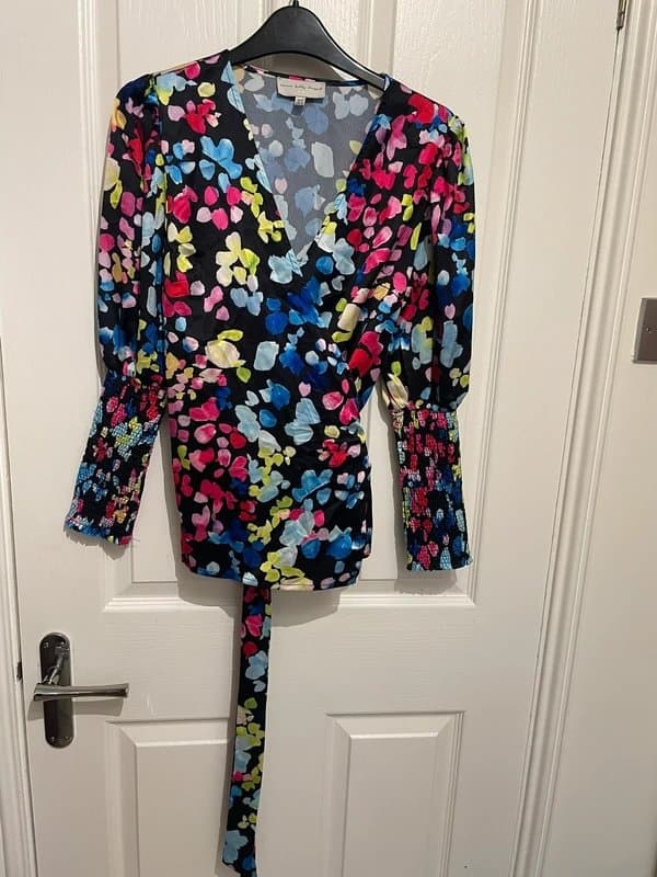 Never Fully Dressed Never Fully Dressed blouse, black, with red, pinks, blues, yellow, green. Size UK 10
