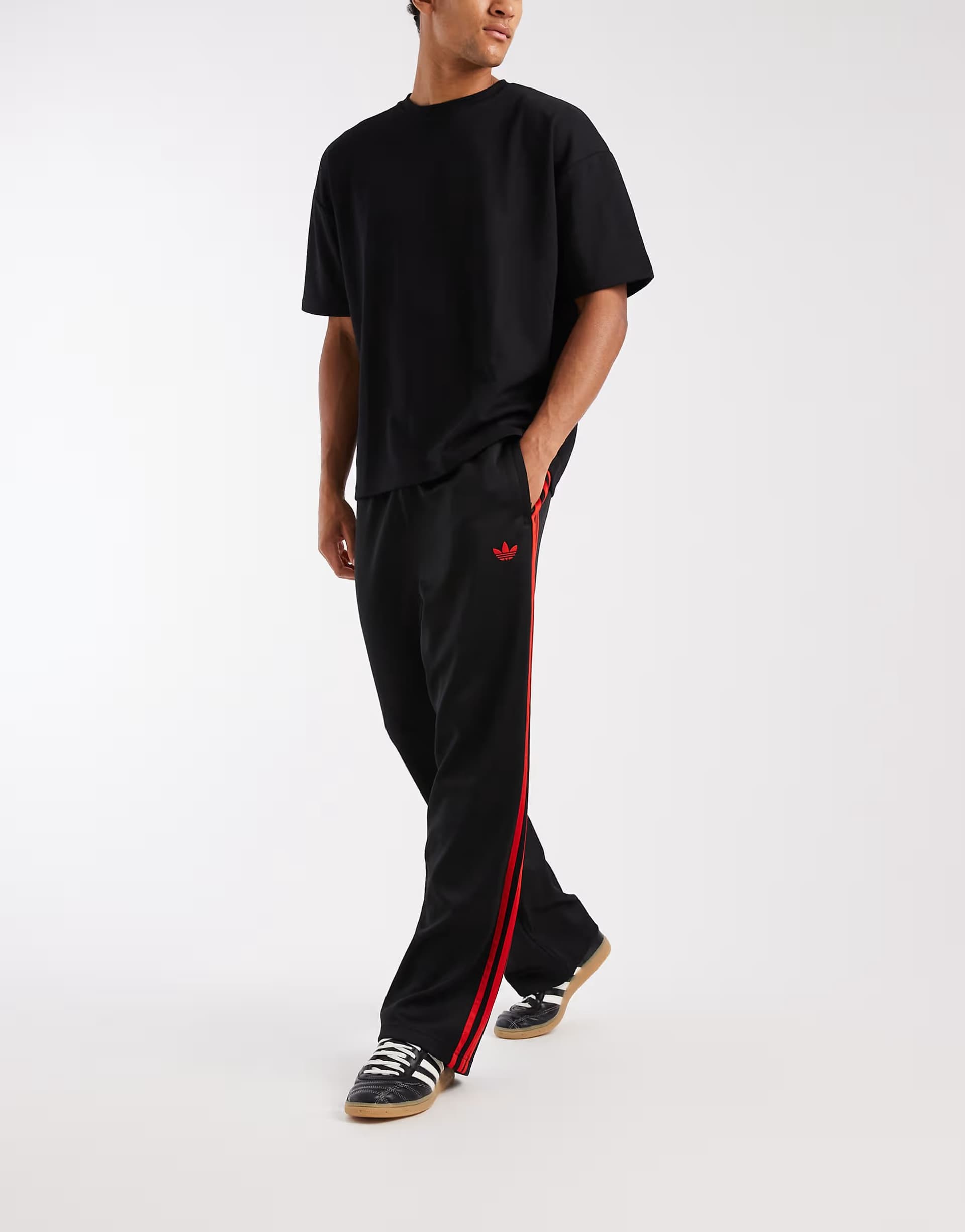 ASOS adidas Originals Adicolor loose trackpants in black / vivid red