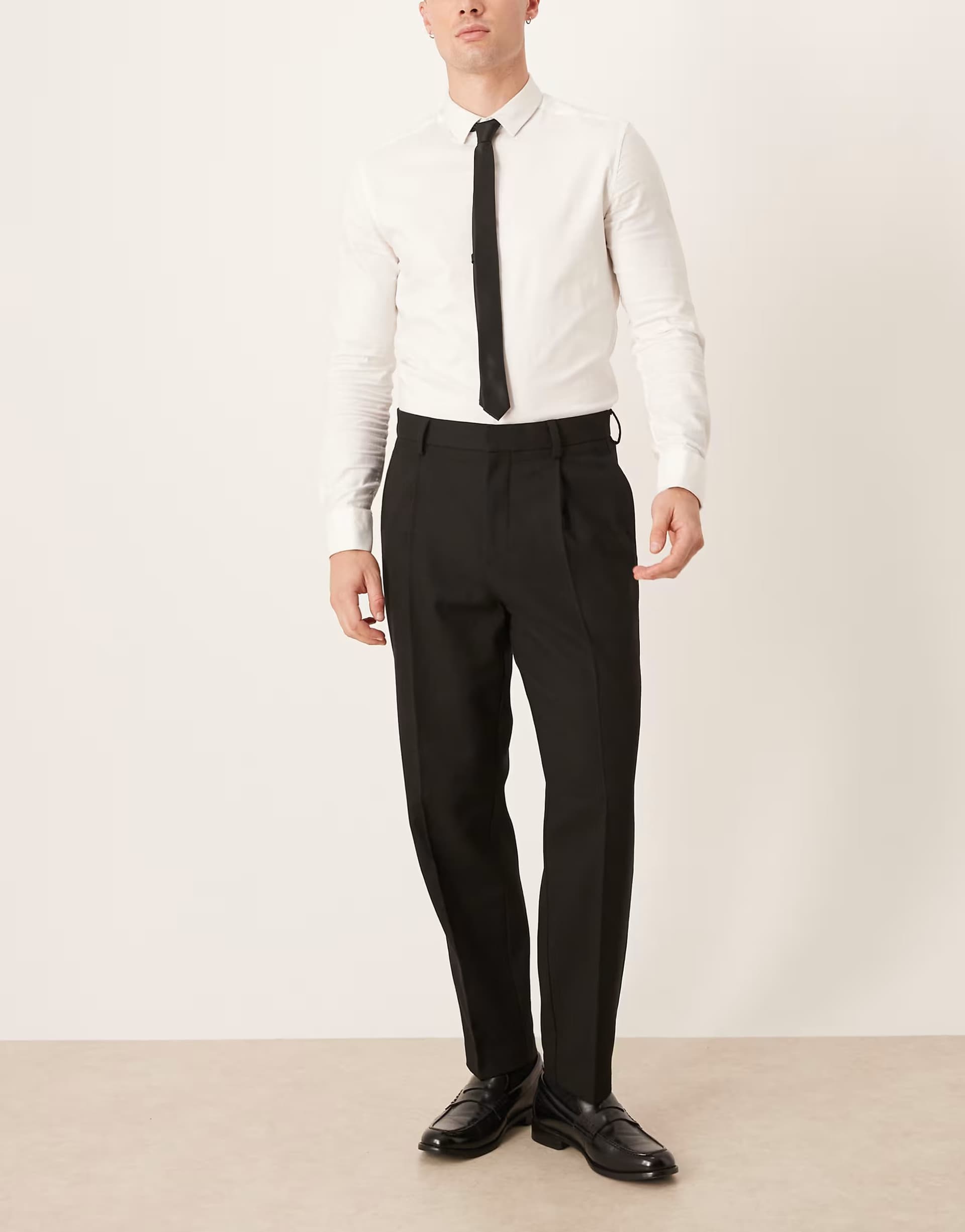 ASOS ASOS DESIGN smart pleated relaxed tapered leg trousers and pocket detail in black herringbone wool mix