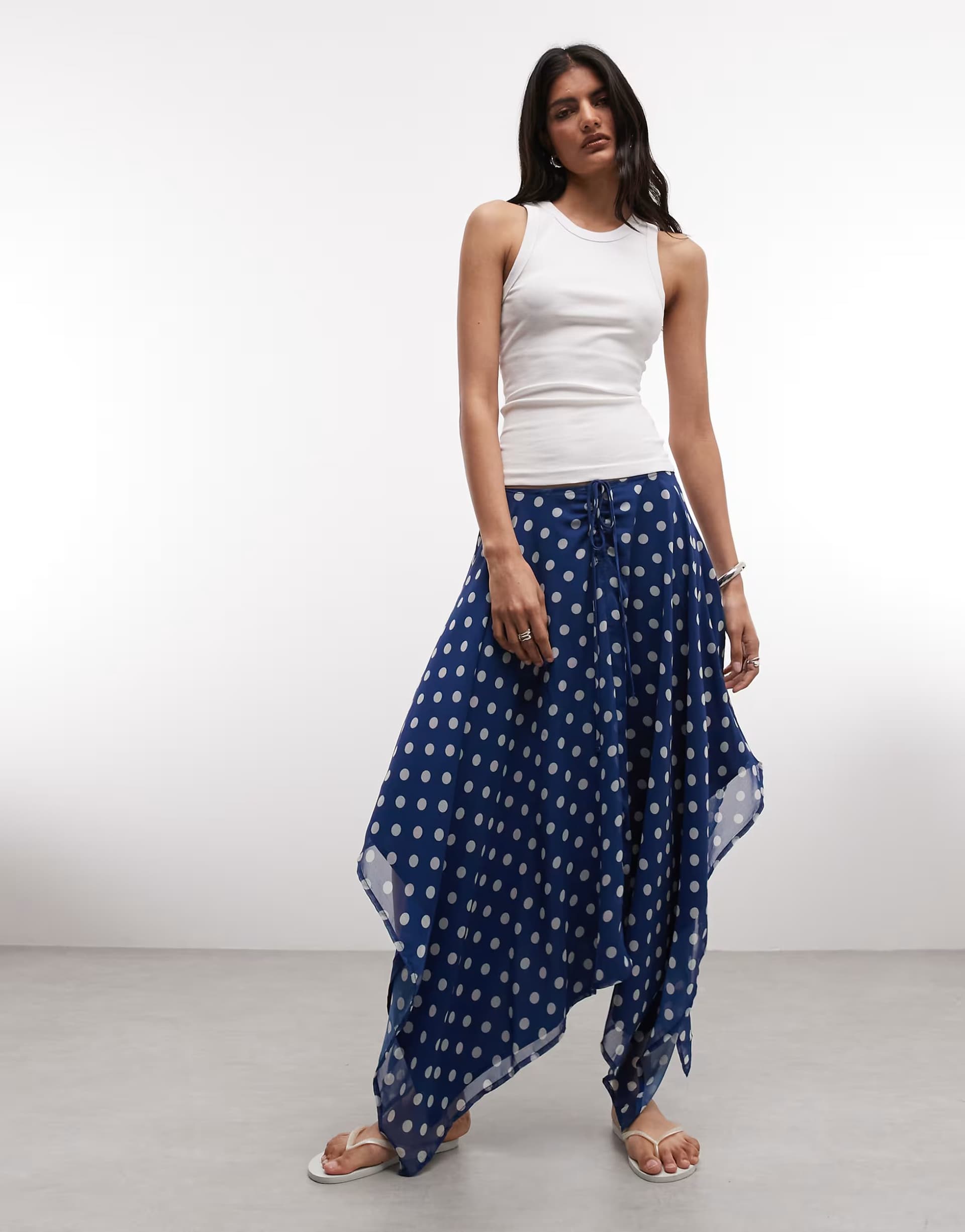 ASOS Reclaimed Vintage ruched midi skirt with asymmetric hem in navy polka dot print