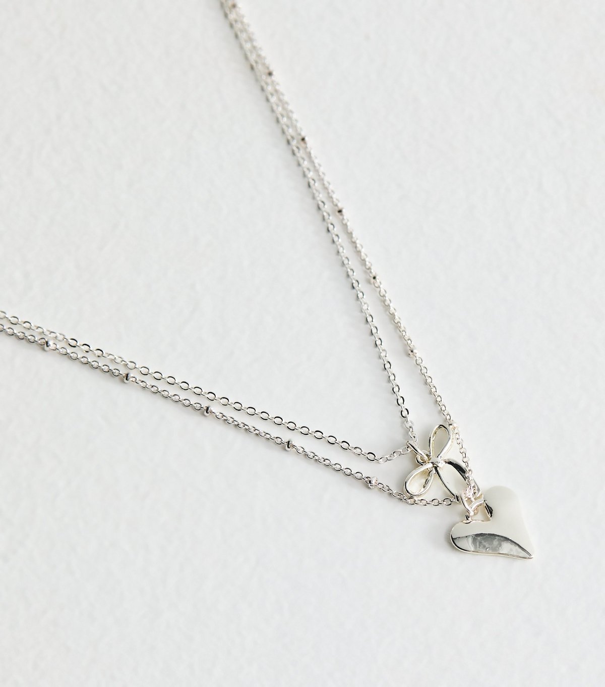 New Look Silver Tone 2 Layer Bow and Heart Pendant Necklace New Look - 3