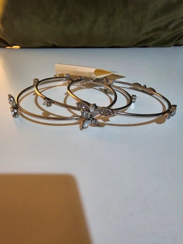 New Look New look set of three silver-toned bangle bracelets with floral details and clear stones