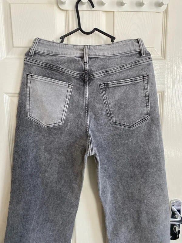 M.Sara Denim grey straight-leg jeans featuring a two-tone split design and a raw hem