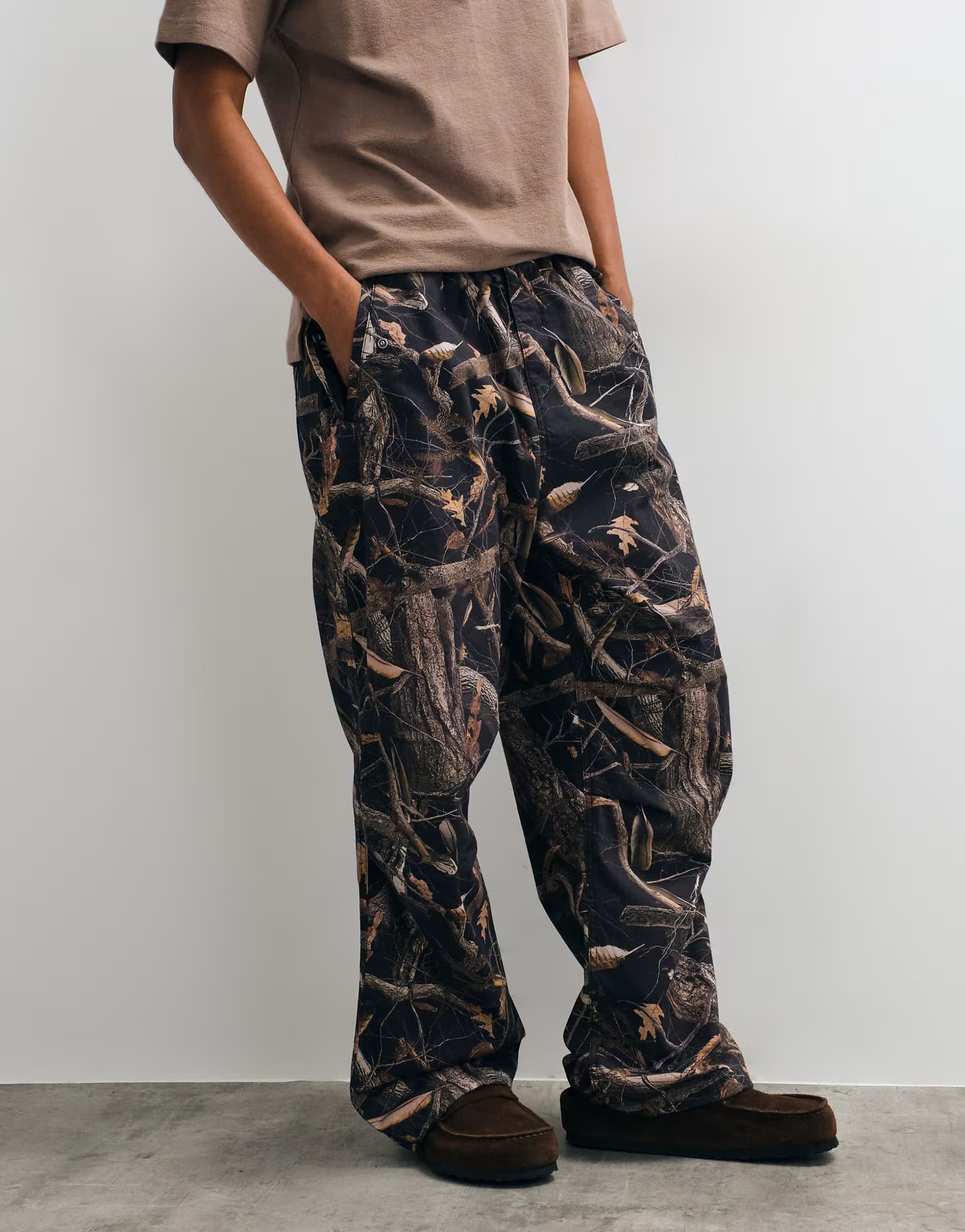 ASOS Carhartt WIP Fletcher straight leg trousers in dark camo tree print
