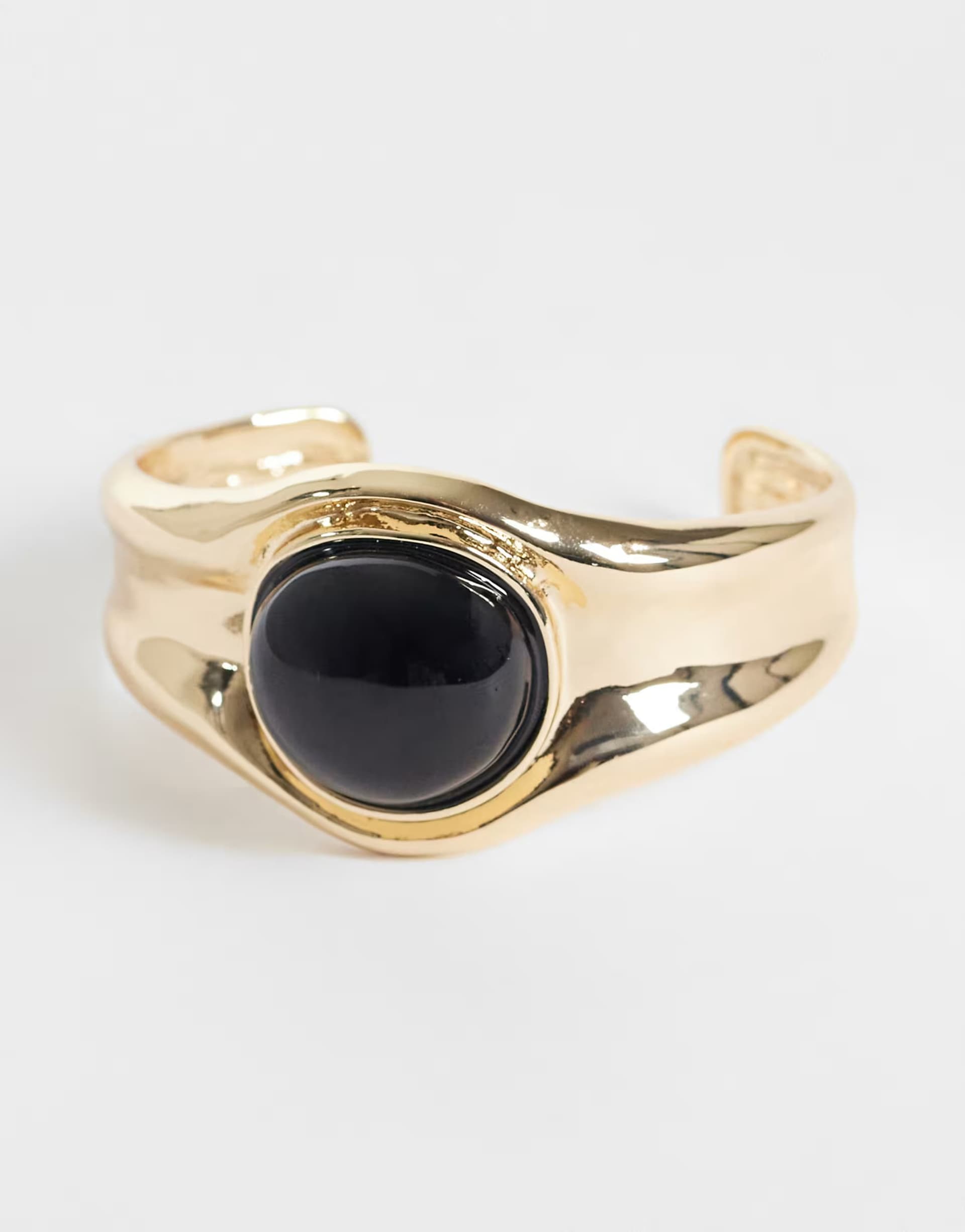 ASOS ASOS DESIGN Cuff bracelet in gold tone with black stone set