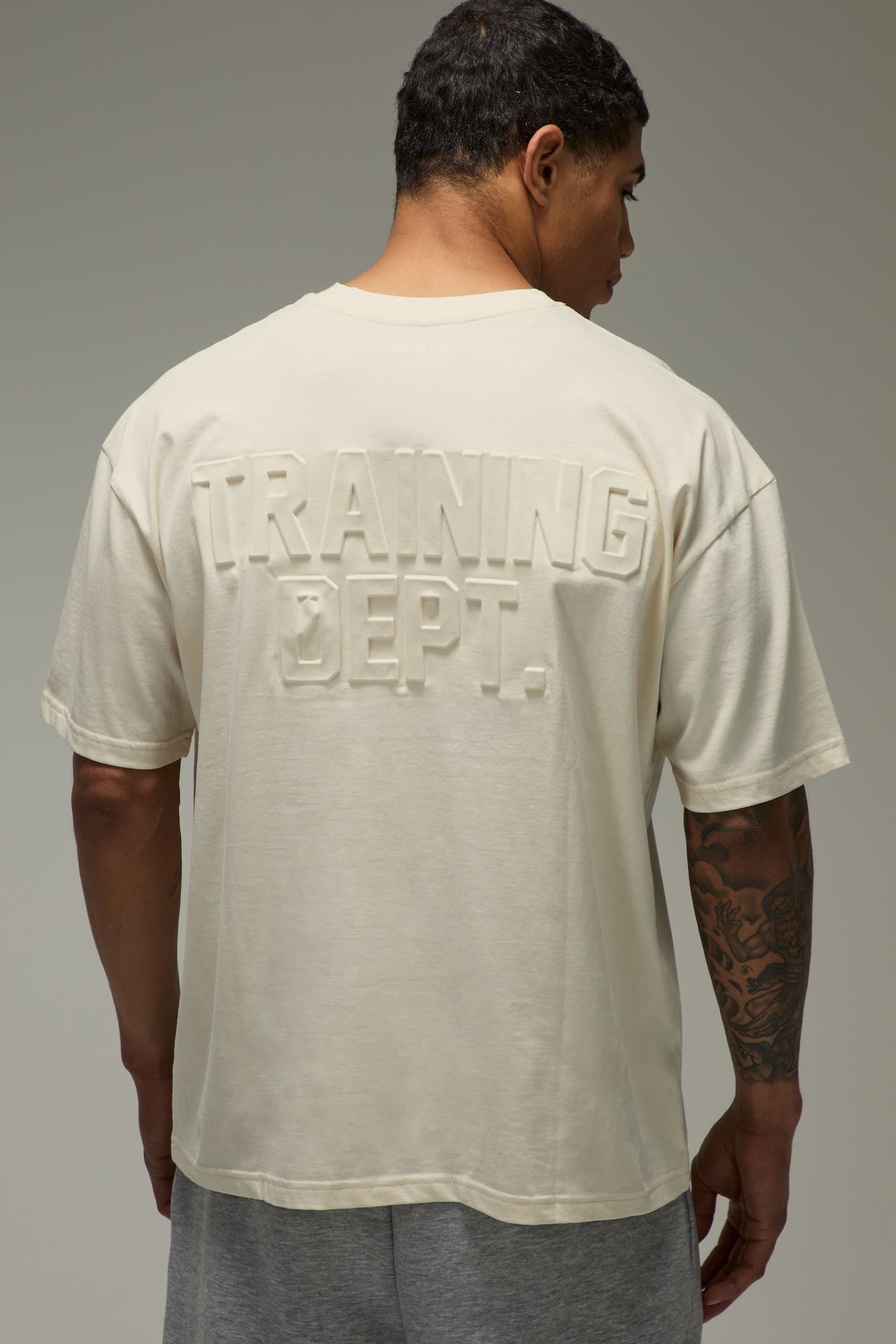 Training Dept. Training Dept. Men's Training Dept Oversized Embossed T-shirt in Off-White