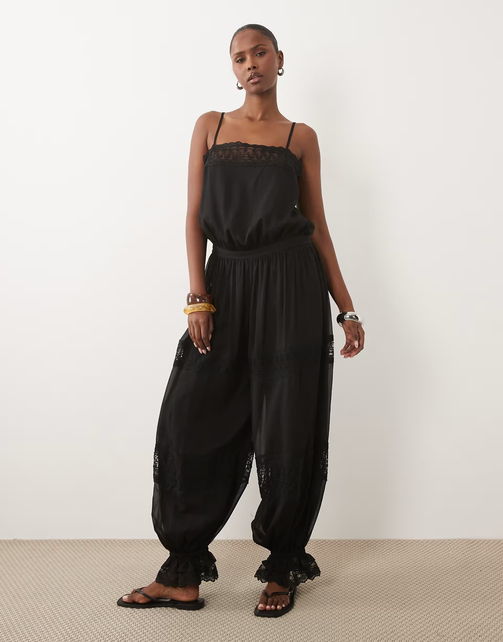 ASOS ASOS DESIGN sheer lace jumpsuit with bubble hem in black