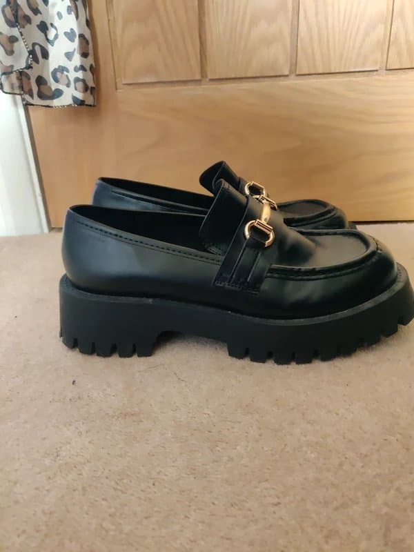 ASOS black loafers with gold buckles