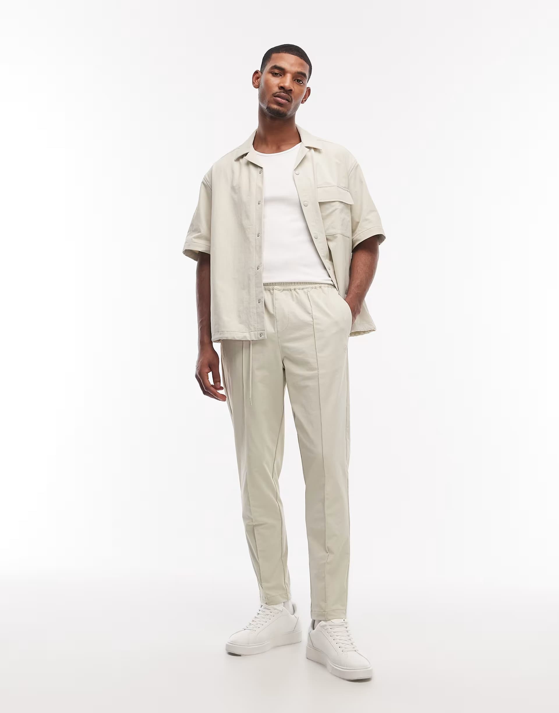 ASOS ASOS DESIGN motionMAX™ four way stretch co-ord tapered trousers in beige with pintucks