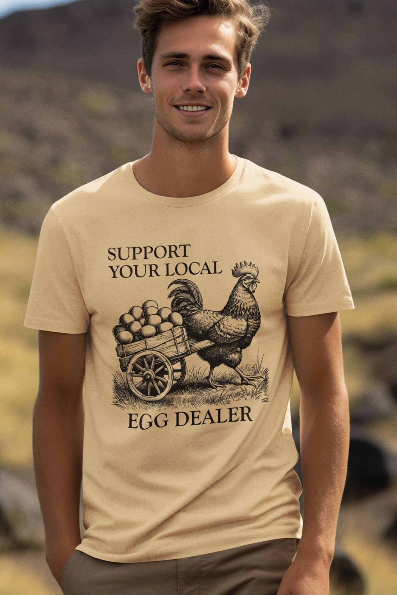 Bad Zebedee Bad Zebedee Men's Support Your Local Egg Dealer Chicken T-Shirt in Light Sand