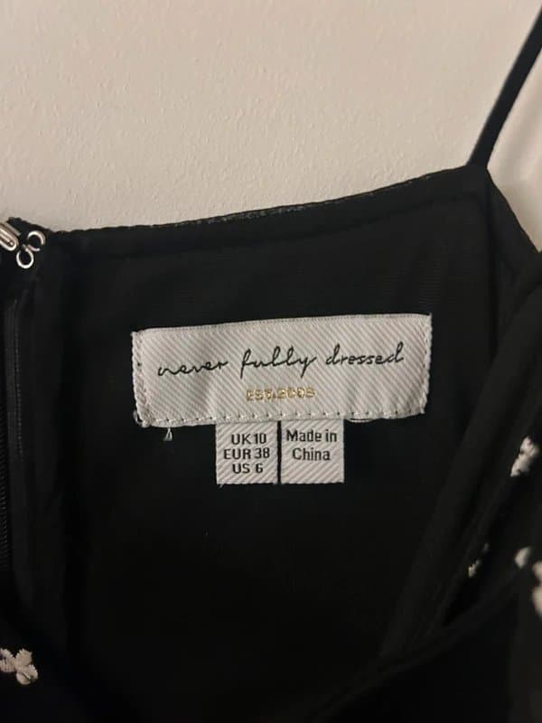 Never Fully Dressed Never Fully Dressed black dress with white embroidered flowers. Size 10