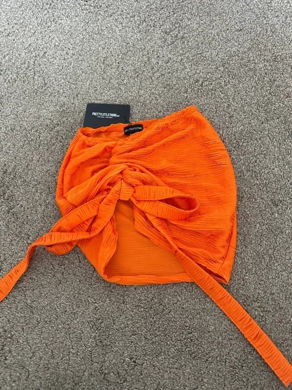 PrettyLittleThing PLT shape orange crinkle ruched tie detail mini skirt
