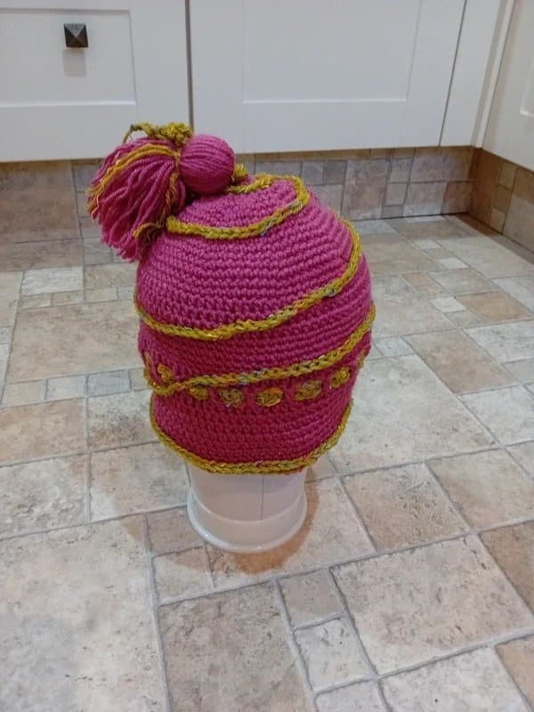 CRAFTED Helmet style beanie with tassle and braids